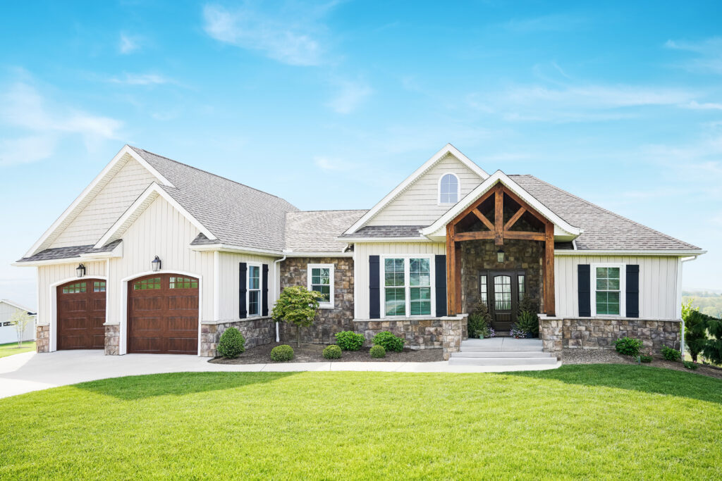 Antique white ProVia board and batten vinyl siding with stone accents on a large craftsman-style Kentucky home.